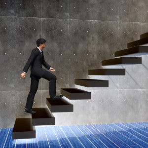 A businessman is walking up a set of stairs.