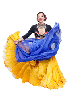 A woman in a yellow and blue skirt is dancing.