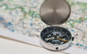 A compass on top of a map.