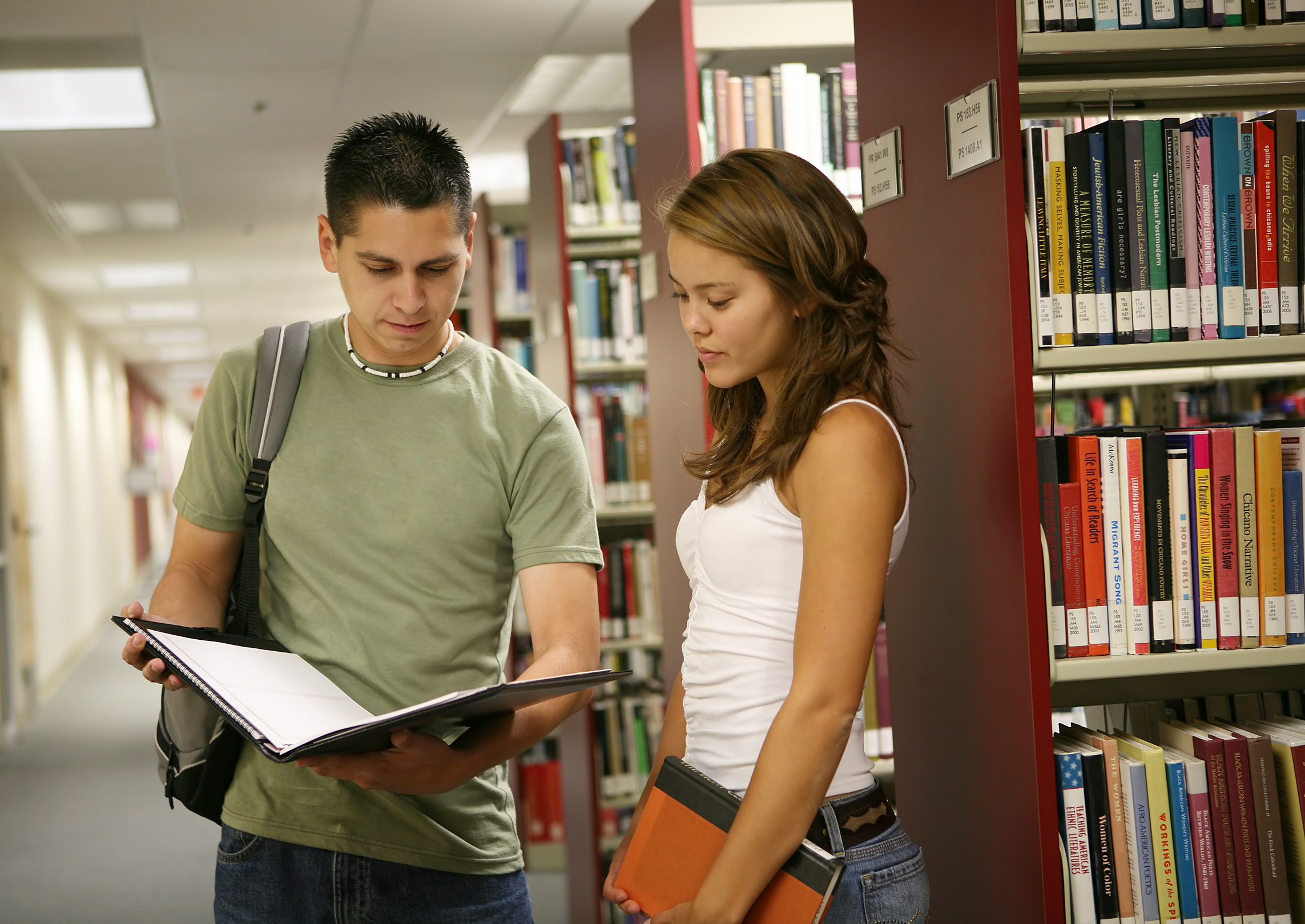 A man and a woman in a library.