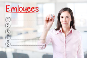 A woman is writing on a board with the word employees.