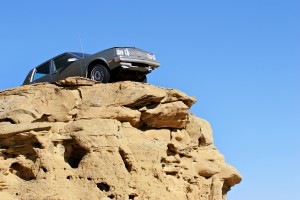 A car on top of a rock.