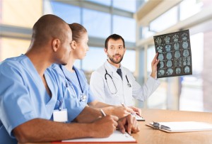 A group of doctors looking at an mri image.