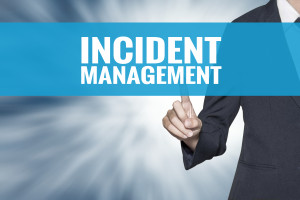 A businessman pointing to the word incident management.