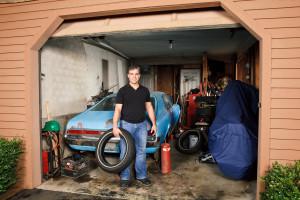 A man standing in a garage.