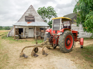 A red tractor parked in front of a house.