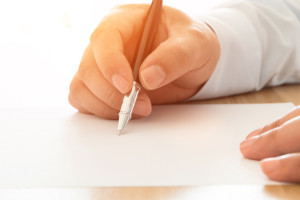 A man filling forms with a pen