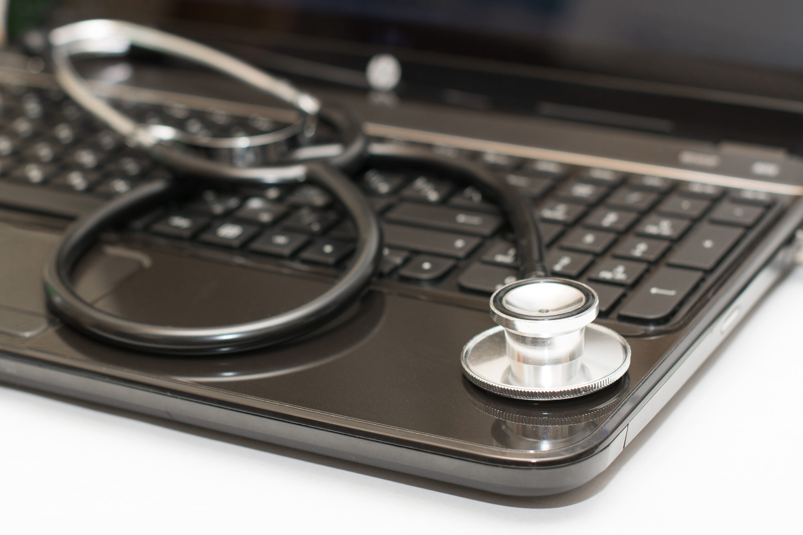 A stethoscope on a laptop.