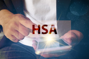 A man holding a phone with the word hsa on it.