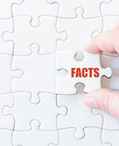 A person holding a puzzle piece with the word facts written on it.