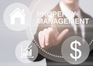 A businessman is pointing to the word property management.