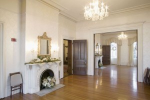 A large room with a fireplace and chandelier.