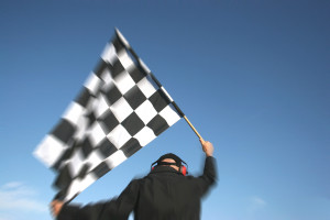 A man waving a checkered flag.