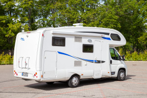 A white motorhome parked in a parking lot.