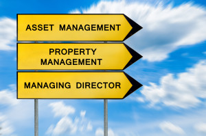 Three yellow signs with the words asset management property management and managing director.