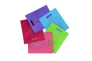 Four colorful plastic shopping bags on a white background.