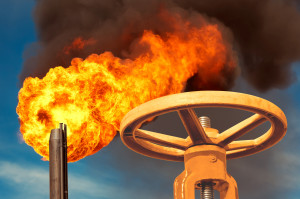 An oil well with a flame coming out of it.