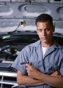 A man standing in front of a car.