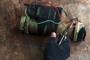 A person using a pair of scissors to remove a wire from a pipe.