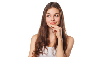 A young woman with her hand on her chin.