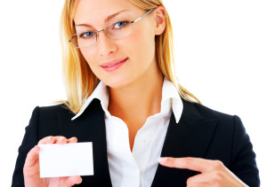 A business woman pointing at a blank card.