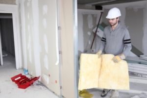 A man in a hard hat is holding a piece of paper.