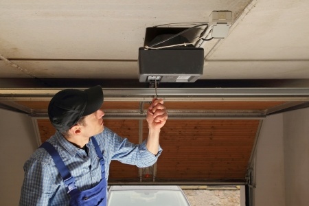 A man working on a garage door.