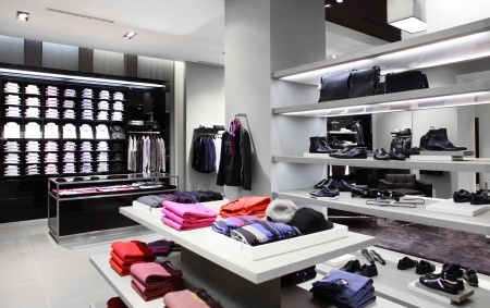 A men's clothing store with a lot of clothes on display.