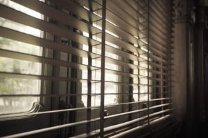 Blinds on a window in a room.