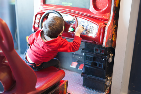 A child is playing a game in a machine.