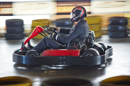 A man driving a go - kart.