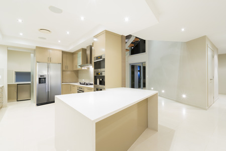 A white kitchen with stainless steel appliances.