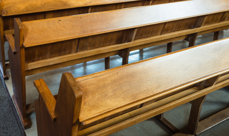 A row of wooden pews in a church.