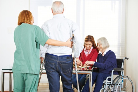 A group of elderly people playing a game of chess in a nursing home.