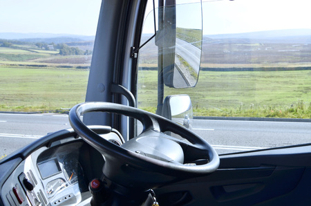 The steering wheel of a truck.