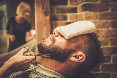 A man getting a haircut in a barber shop.