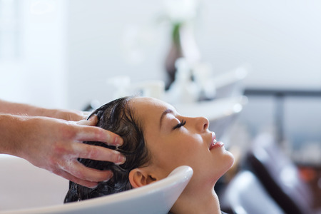 A woman getting her hair washed in a salon.