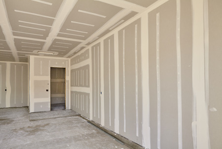 A room that is being remodeled with drywall and plaster.