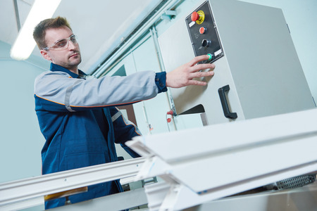 A man is working on a machine in a factory.