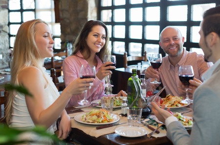 A group of people enjoying a meal in a restaurant.