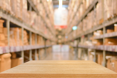 A wooden table in a warehouse.