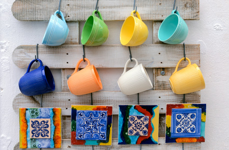 Mugs hanging on a wooden wall.