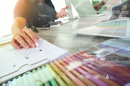 A group of people working at a desk with paper and graphs.