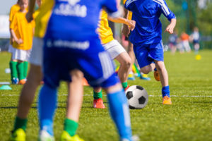 A group of kids playing soccer on a field.