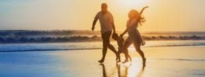 A Couple With a Boy Walking on the Shore